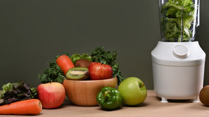Fresh green vegetables, fruits and blended on wooden table. Healthy food concept.