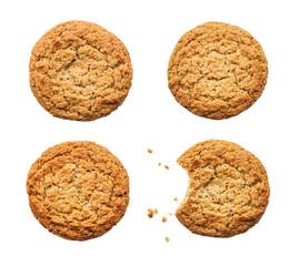 Four oatmeal round cookies. One cookie is bitten and crumbs lie isolated on white background top view