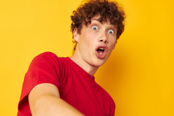 cute guy with curly hair in a red t-shirt close-up