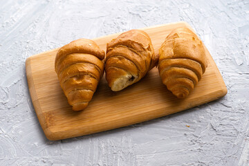 croissants on a wooden board on the table