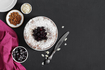 pie with frozen berries and almonds on a dark background. top view, copy space