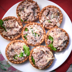 Tartlets with cod liver and herbs