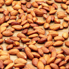 Almonds on a wooden surface.