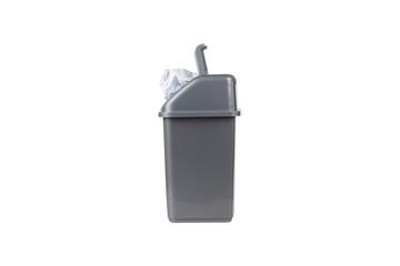 gray trash can full of crumpled paper on white background