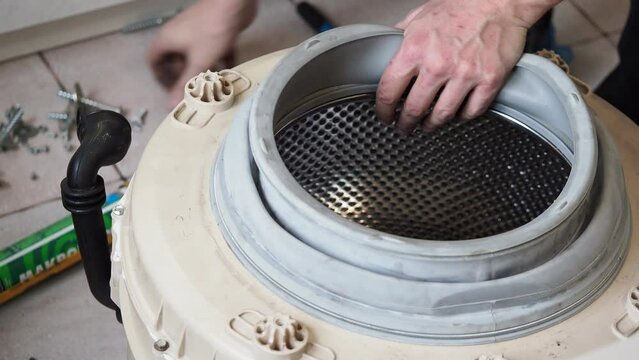 master services man disassembles into a washing machine  repair