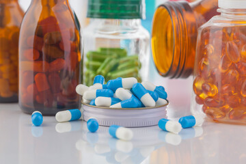 medicine bottle and pills on white background