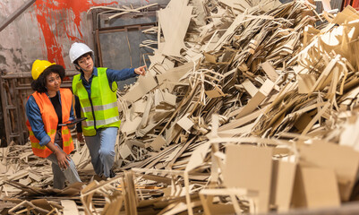 Engineer Standing to work with tablet Machines in the recycling industryl worker indoors in...