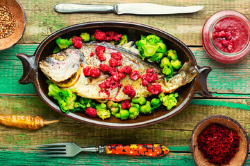 Appetizing gilthead fish in berry sauce.