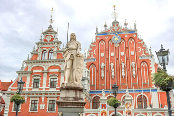 Fototapeta na wymiar The House of the Blackheads and the statue of Roland in the center of the old town of Riga - colorful postcard of the capital of Latvia with a cloudy background
