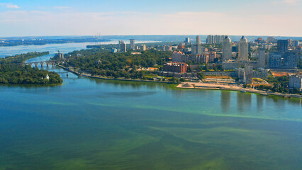 Beautiful urban environment on a summer day.  Aerial view of the summer landscape with a view of the river and the city on the shore.