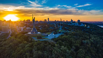 Fotobehang Aerial view to the Motherland statue in the Kiev while  summer sunset. The well-known landmarks in Kyiv. Historical monument of Soviet union. Beautiful city Kiev while sunset. © Valua Vitaly