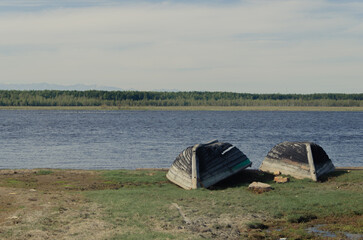 A couple of wooden boats are drying on the banks of the Barguzin River.