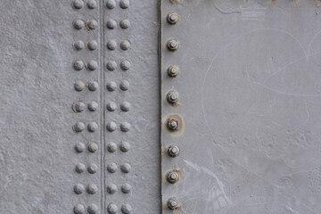A close-up of metal plates with rivets
