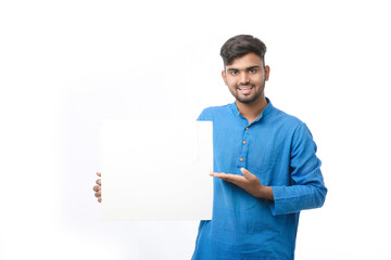 Indian man wearing traditional cloths and showing board on white background.