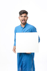 Indian man wearing traditional cloths and showing board on white background.