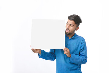 Indian man wearing traditional cloths and showing board on white background.