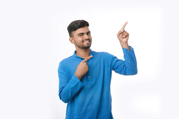 Fototapeta premium Indian man in tradition wear and giving expression on white background.