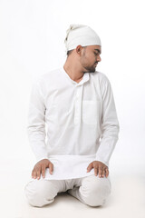 Indian muslim religious man praying on white background.