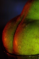Green pear close-up in drops. Vegetarianism, healthy eating, body, fitness
