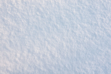 The surface is covered with an even layer of fresh fluffy snow. Background. Texture.