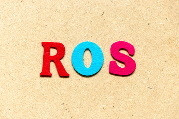 Color cloth alphabet letter in word ROS (Abbreviation of Return on sales) on wood background