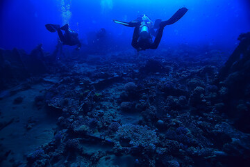 Fototapeta premium divers underwater at depth in the blue sea background