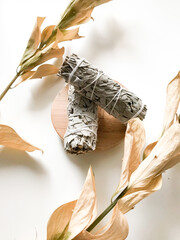 california white sage, beautiful layout and top view, incense and dried flowers on a white background