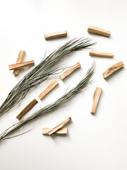 a very beautiful background of wooden palo santo sticks, aromatherapy and the magic of aromas on a white background. Light image blurring, lack of focus, soft texture combinations.