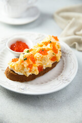 Scrambled eggs toast with cream cheese and caviar
