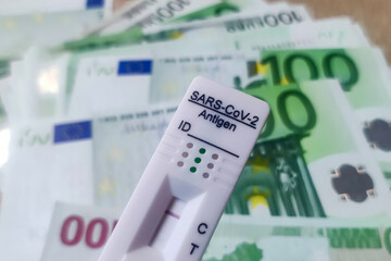 Coronavirus rapid antigen test with euro banknotes. Corona virus SARS-Cov-2 fast negative test. test cassette on several euro banknotes concept