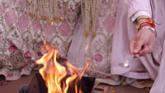 Shot of an Indian Bride and Indian Groom doing Puja,traditions at their Indian wedding in New Delhi, India
