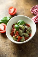 Homemade spinach gnocchi with tomato sauce