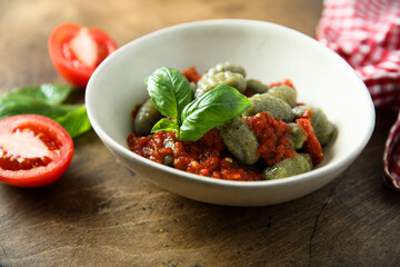 Homemade spinach gnocchi with tomato sauce