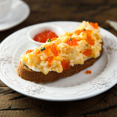 Scrambled eggs toast with cream cheese and caviar