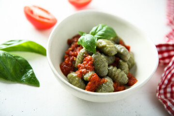 Homemade spinach gnocchi with tomato sauce