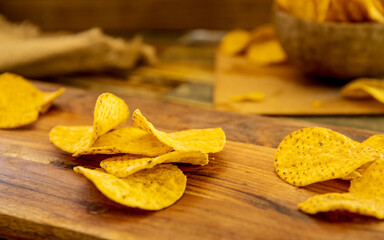 potato chips and beer on wooden background in a cafe, pub or at home