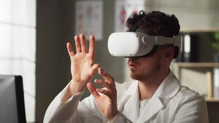Attractive serious responsible skilled male doctors working on virtual screen in special 3d glasses in modern medical workroom