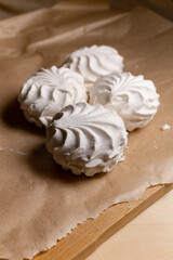 Vanilla white marshmallows are on the cutting board. Vertical image. Sweets for tea.