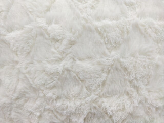 Texture of white fur, faux fur, warm plaid. Light background with fur pattern