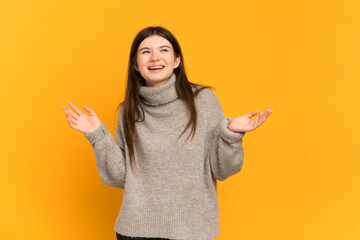 Young Ukrainian girl isolated on yellow background smiling a lot