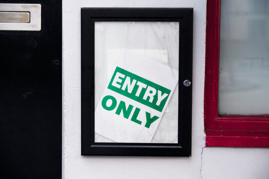 Entry only sign at pub and bar restaurant on wall