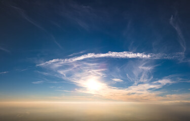 Bright colorful sunset sky with setting sun and vivid soft clouds. Concept of nature and environment