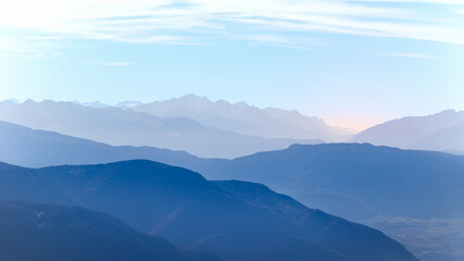 Fototapeta na wymiar Sunrise in the mountains covered with morning haze. Val Gardena, Seiser Alm, Italy