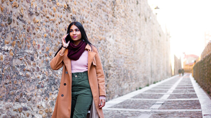 Happy young business woman text messaging at outdoors