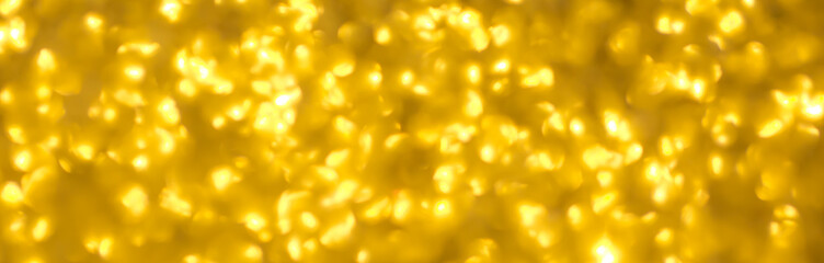 Blurred festive golden background. Bokeh background of yellow Christmas sparkles. Beautiful Christmas decoration of the interior of the house.