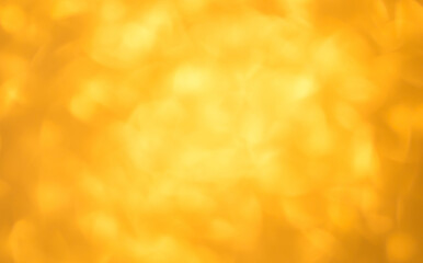 Blurred festive golden background. Bokeh background of yellow Christmas sparkles. Beautiful Christmas decoration of the interior of the house.