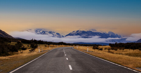 Panoramic view of Banner of traveling on the road with mountain range near Aoraki Mount Cook and the road leading to Mount Cook Village in New zealand	