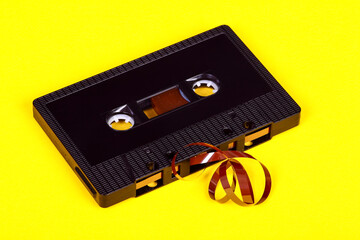 Old vintage retro audio cassette tape after a tape jam where the magnetic tape has unravelled