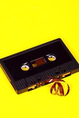 Old vintage retro audio cassette tape after a tape jam where the magnetic tape has unravelled