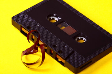 Old vintage retro audio cassette tape after a tape jam where the magnetic tape has unravelled